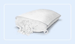 the sealy adjustable pillow with its fill coming out of the pillow to show the materials used inside