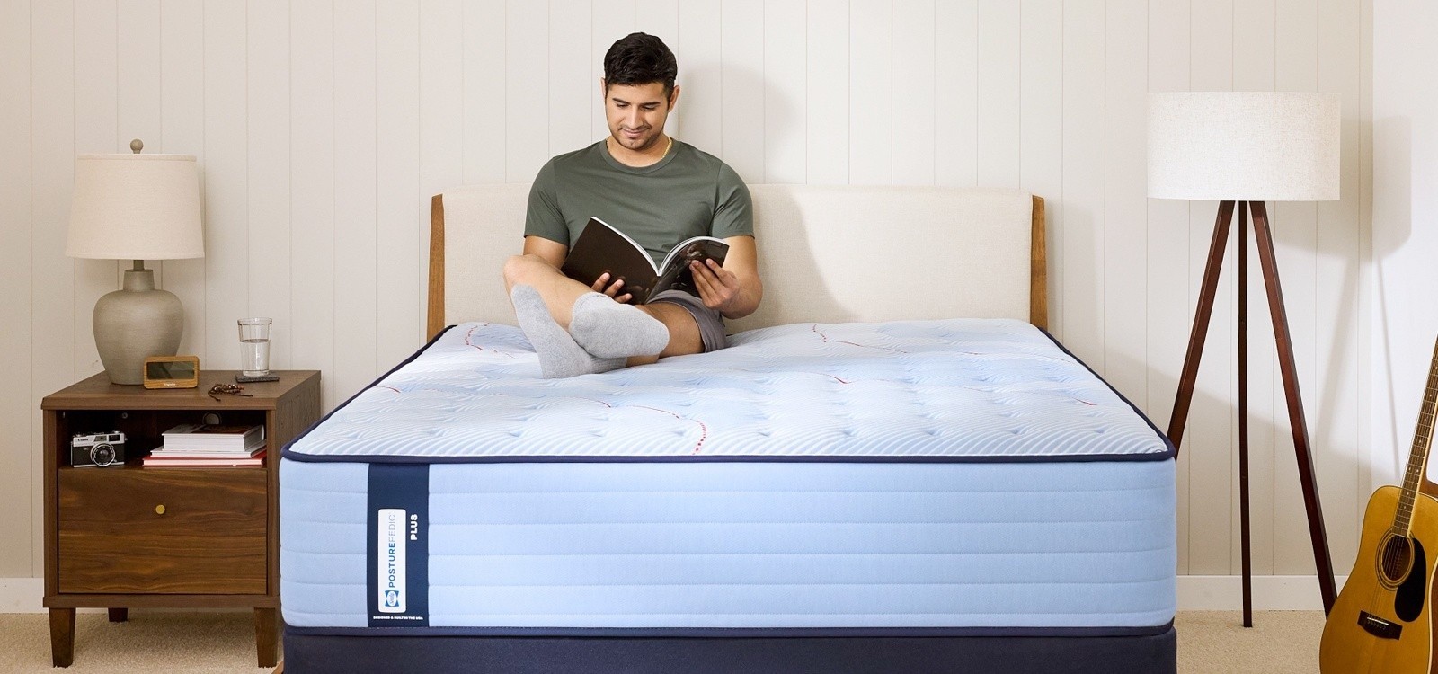 Man lounging on a Posturepedic Plus Spring Tight Top mattress