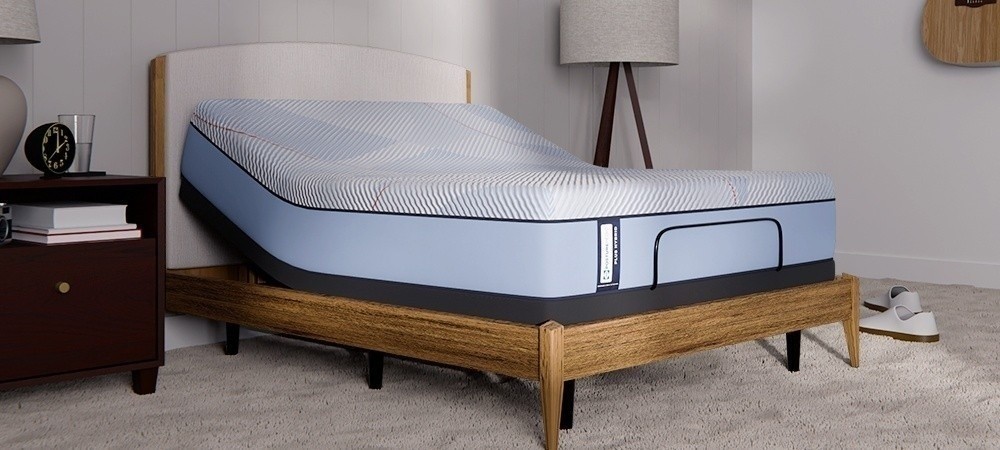 Posturepedic Plus Hybrid mattress on adjustable base in a styled room - mobile