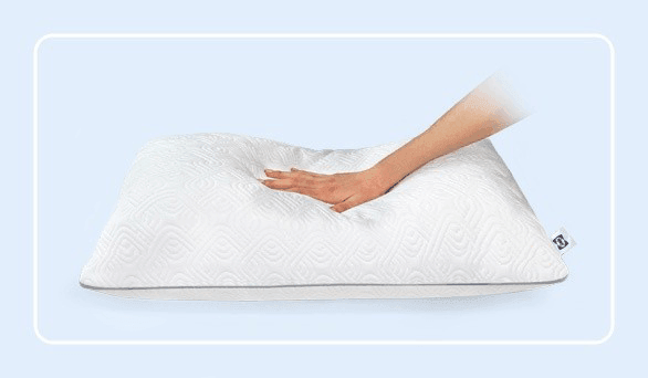 a hand pressing on a sealy adjustable pillow