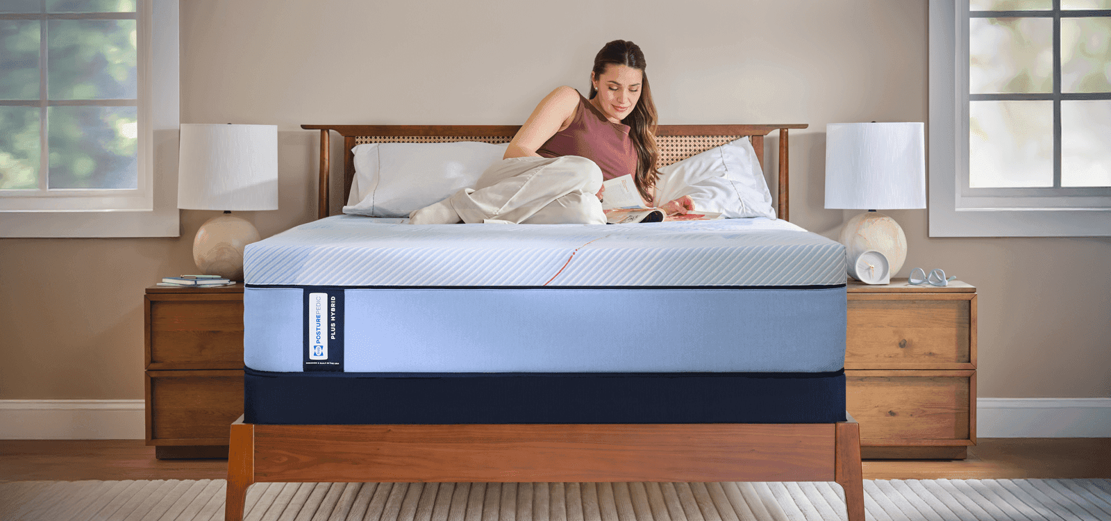 Woman laying on a Posturepedic Plus Hybrid mattress
